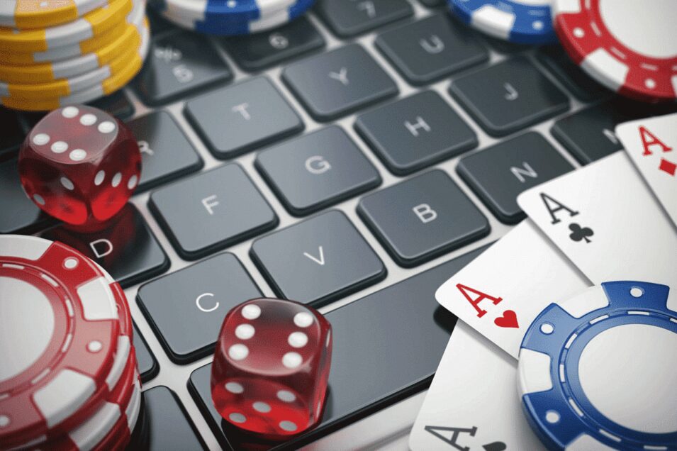 Laptop Keyboard with Poker Chips and Dice. Depiction of Online Casinos